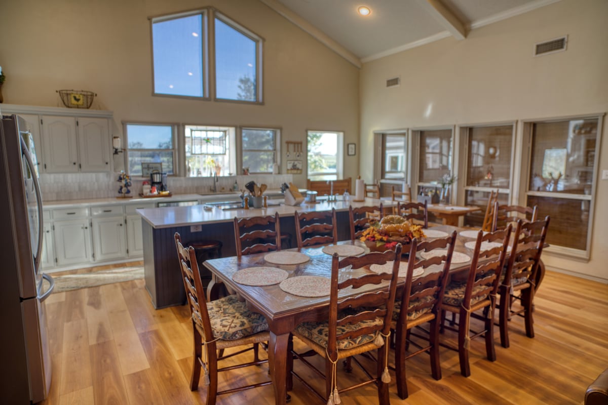 Open great room with a long farmhouse dining table