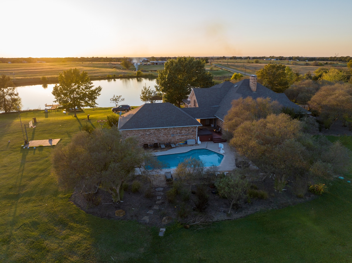 Aerial view of the farmhouse, private pool and pond