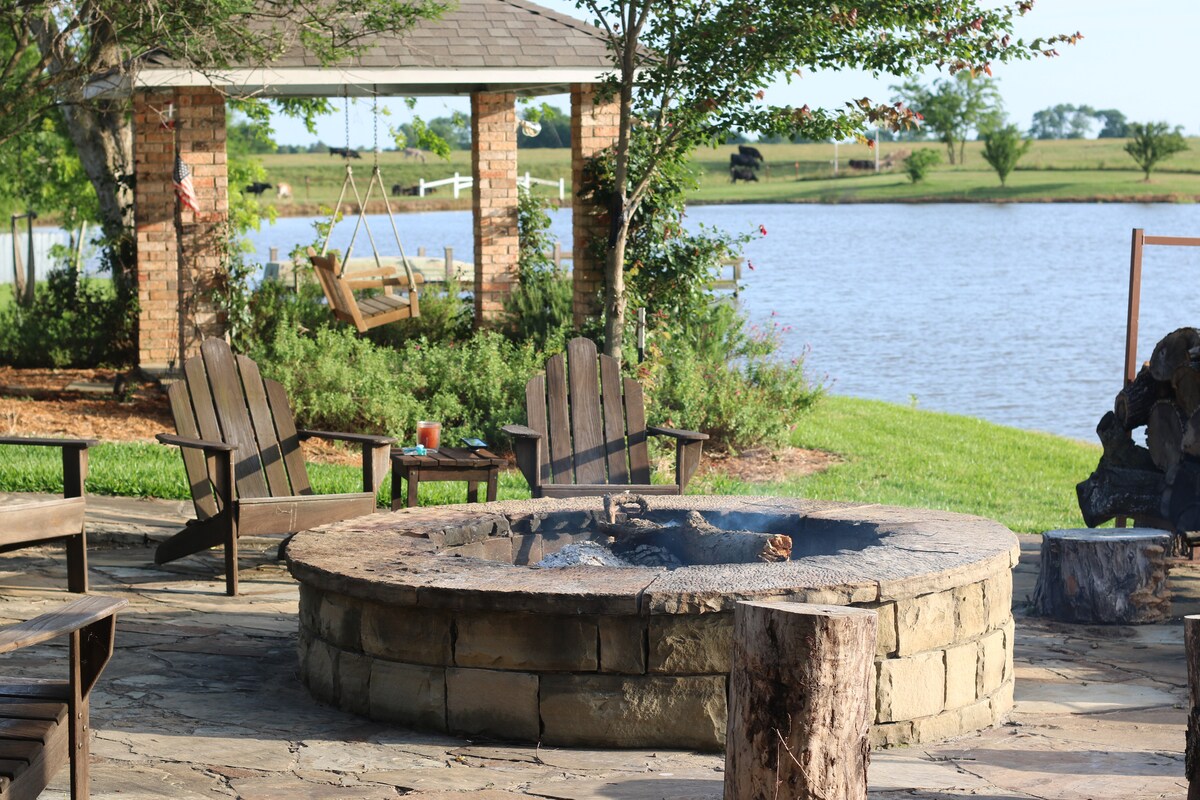 Fire pit with Adirondack chairs by the pond