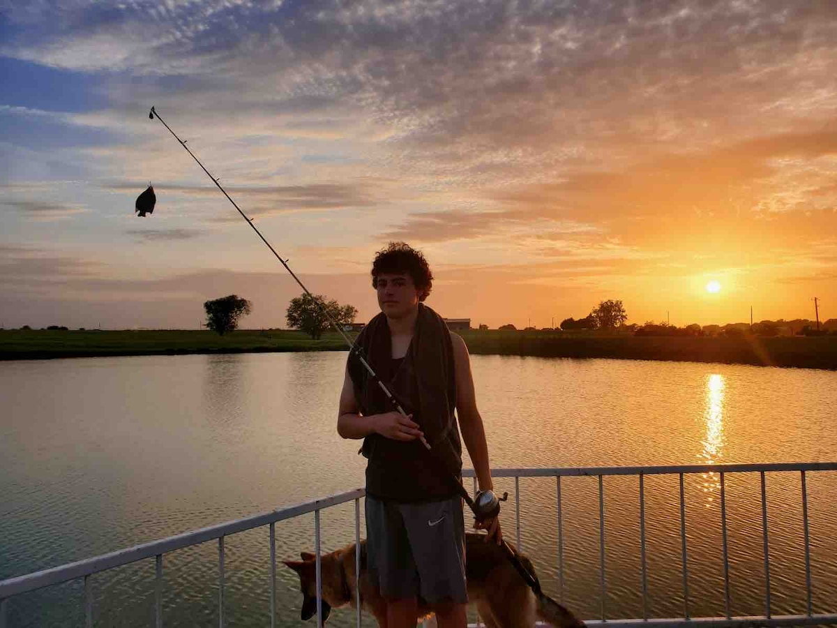 Guest fishing from the dock on the private pond at sunset