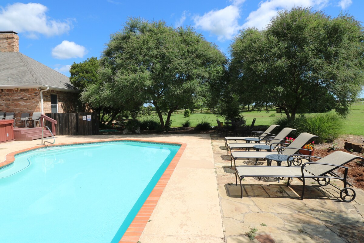 Private swimming pool with sun loungers beside the farmhouse