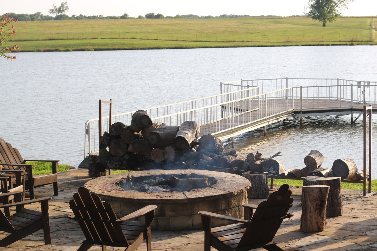 Fire pit and chairs by the pond at dusk