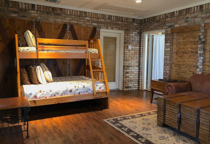 Bunk room with brick accent wall